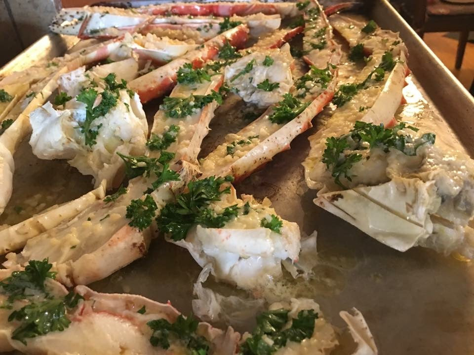 Delicious split Alaskan King Crab Legs with parsley, ready to grill. 4-7 count, colossal size.