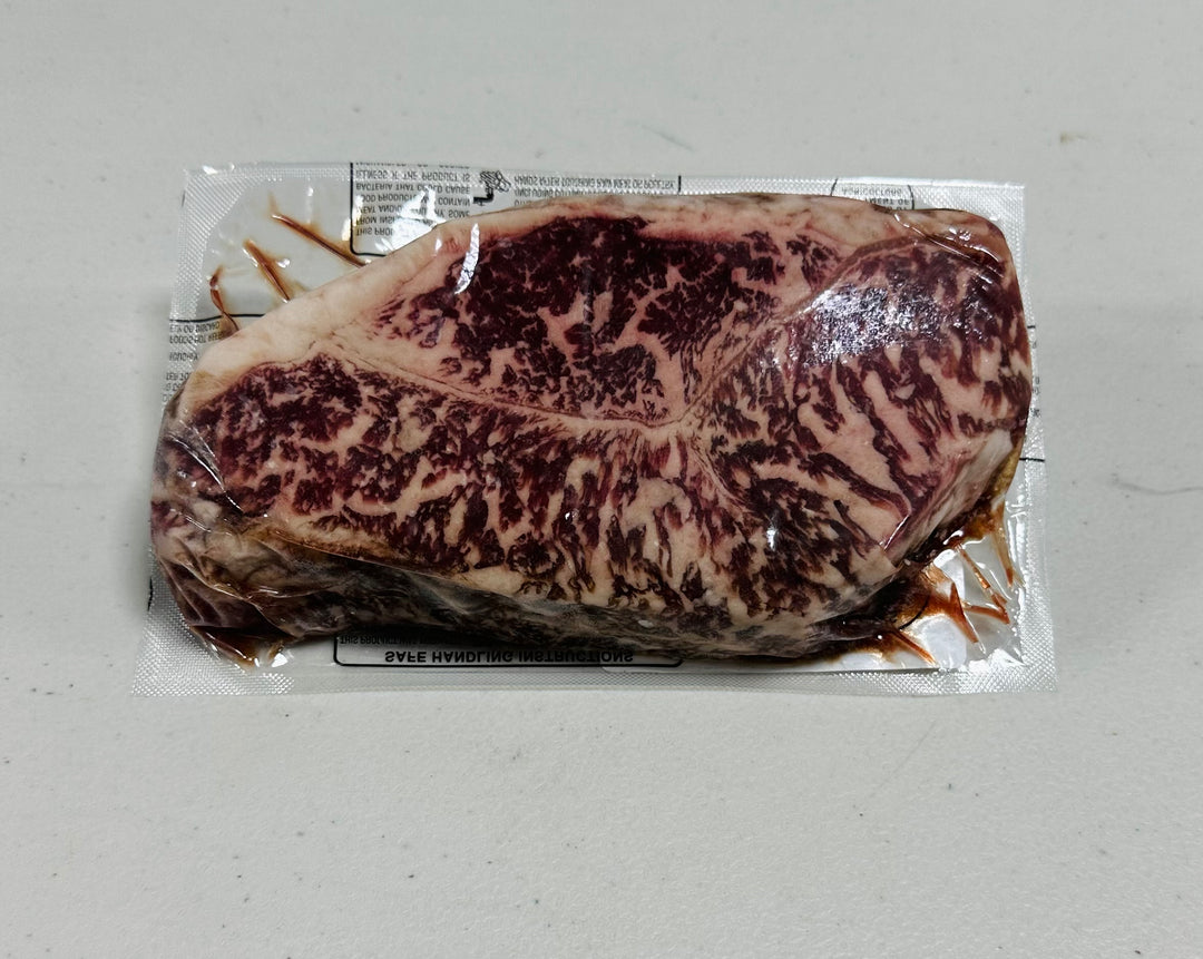 Australian Wagyu New York Strip End Cut, Marble Score 7+, 14oz. Richly marbled, premium steak.