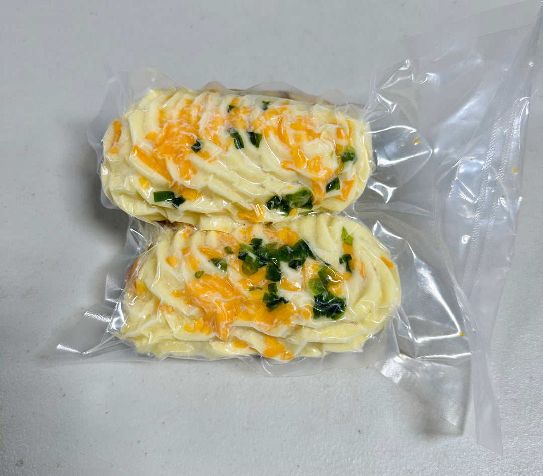 Close-up of Second City Prime Twice Baked Potatoes on a white plate. Delicious gourmet side.