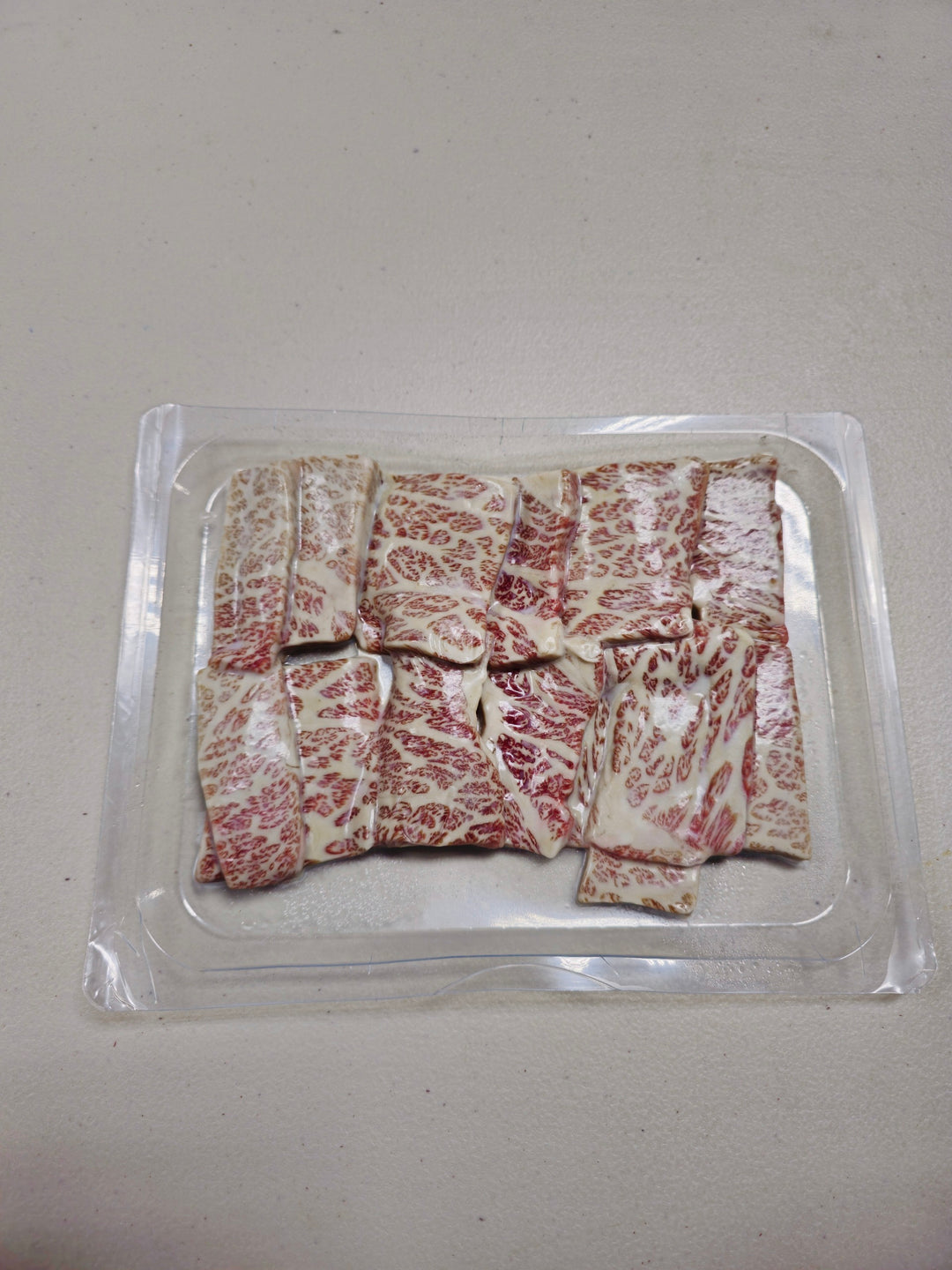 Package of Japanese Wagyu A5 Yakiniku Style Short Ribs, showcasing the marbling.