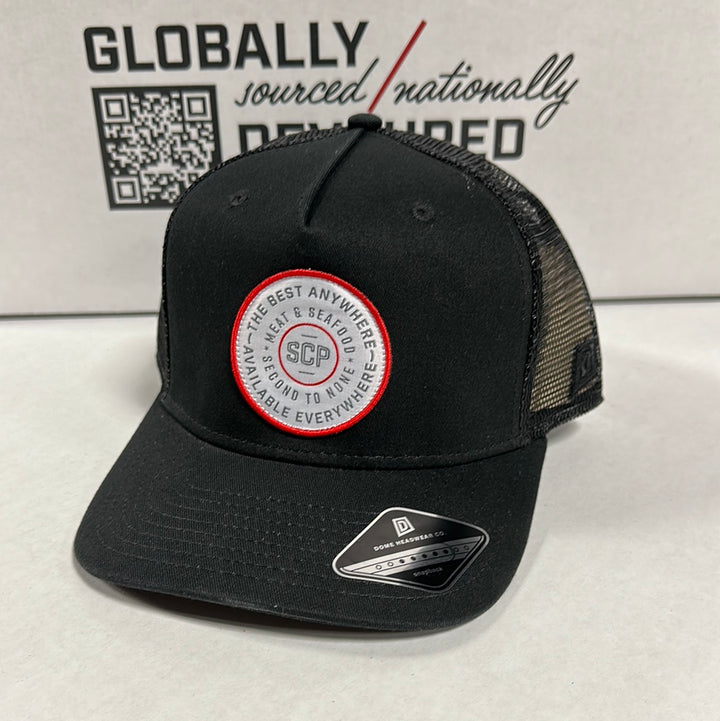 Front view of the Black SCP Logo Deep Trucker Hat. Features the round SCP logo on a black cap.