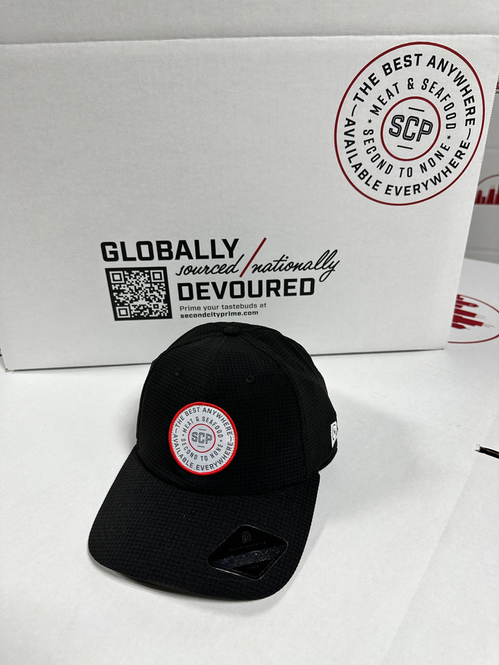 Black SCP golf hat with mesh texture and embroidered SCP logo.
