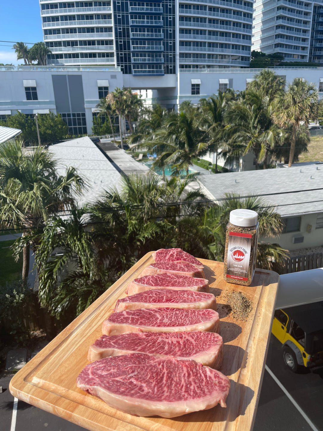 Stone Axe Australian Wagyu Picanha steaks, marble score 9+, sliced on a wooden board with Second City Prime steak rub.