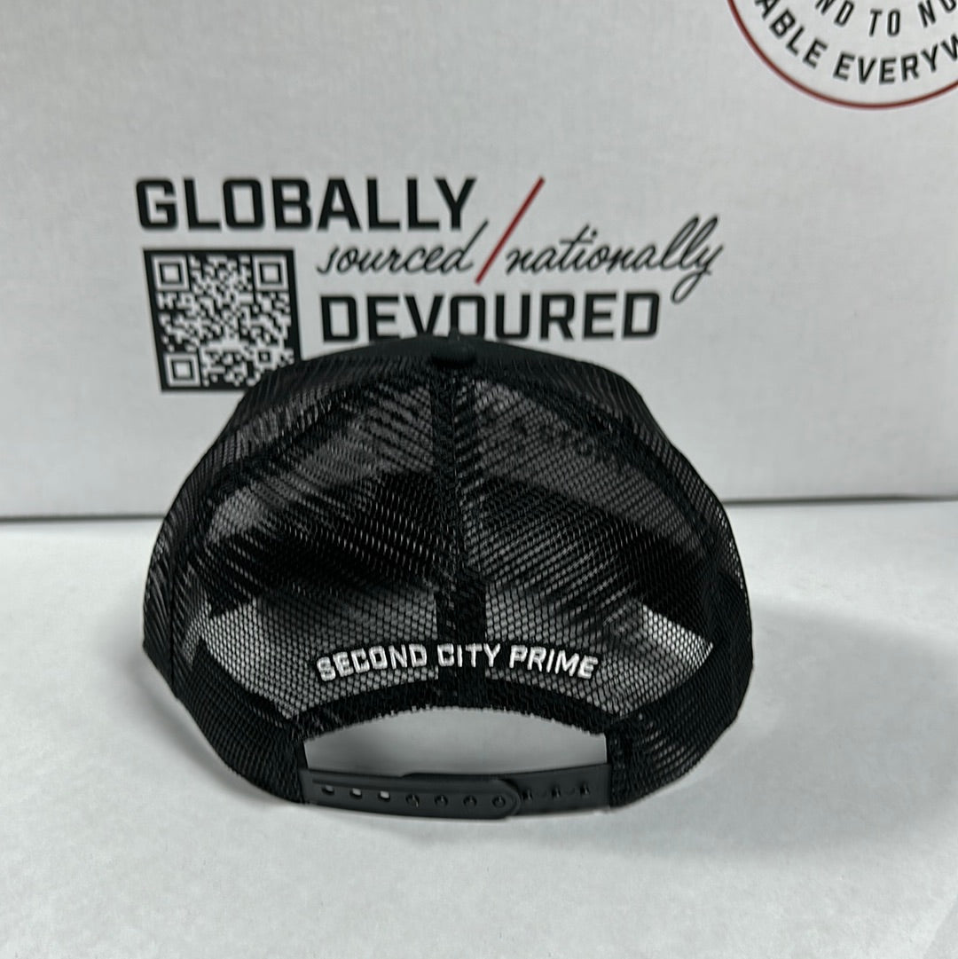Back of Black SCP Trucker Hat. Shows mesh back and 'Second City Prime' text on the adjustable strap.