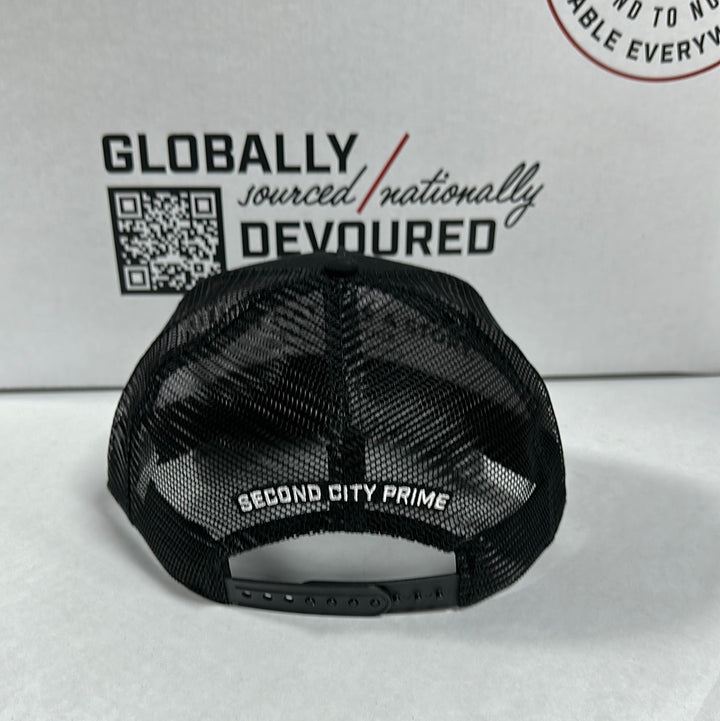 Back of Black SCP Trucker Hat. Shows mesh back and 'Second City Prime' text on the adjustable strap.