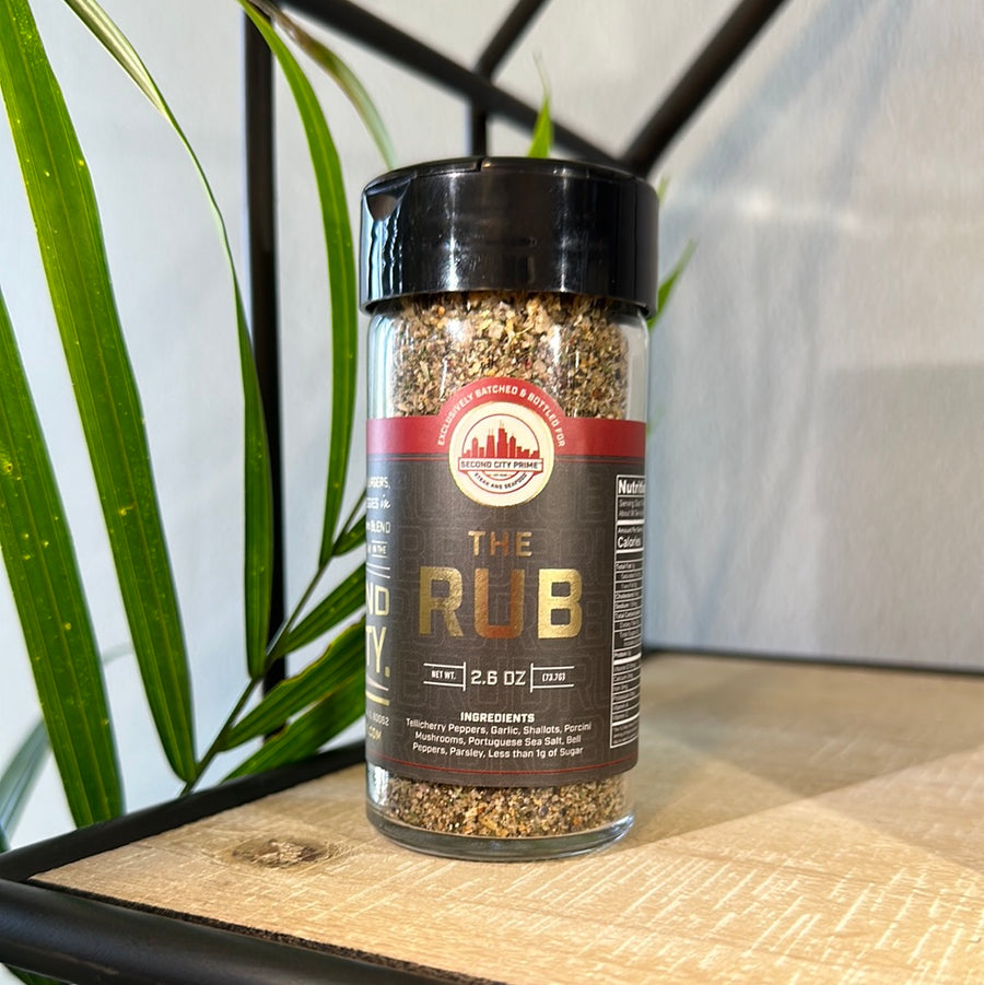 The Rub seasoning blend in a clear 2.6oz jar, featuring garlic, pepper, and porcini mushrooms.
