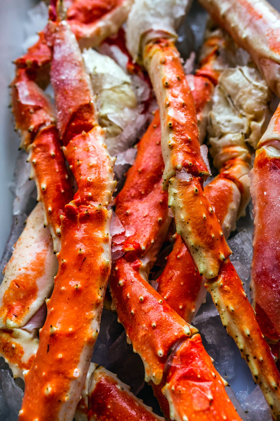 Freshly caught Alaskan King Crab legs with vibrant orange shells, perfect for a holiday feast.