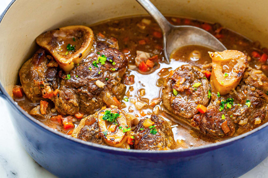 Tender lamb shanks braised in a flavorful sauce with herbs and vegetables.