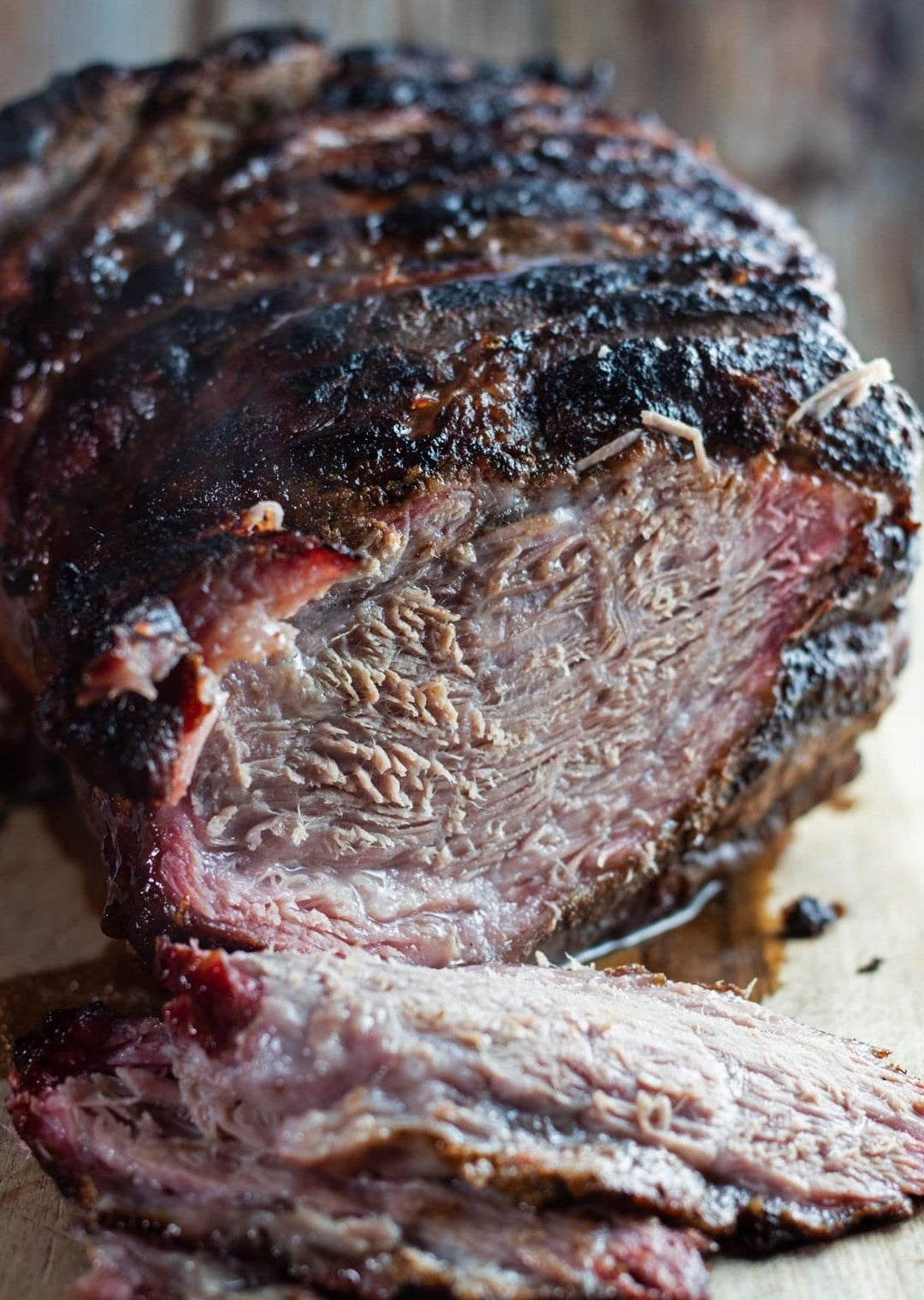 Juicy Mangalitsa Pork Tip Roast with a smoky crust, sliced to show tender meat inside.