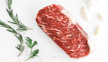 Raw Second City Prime beef with herbs and garlic.
