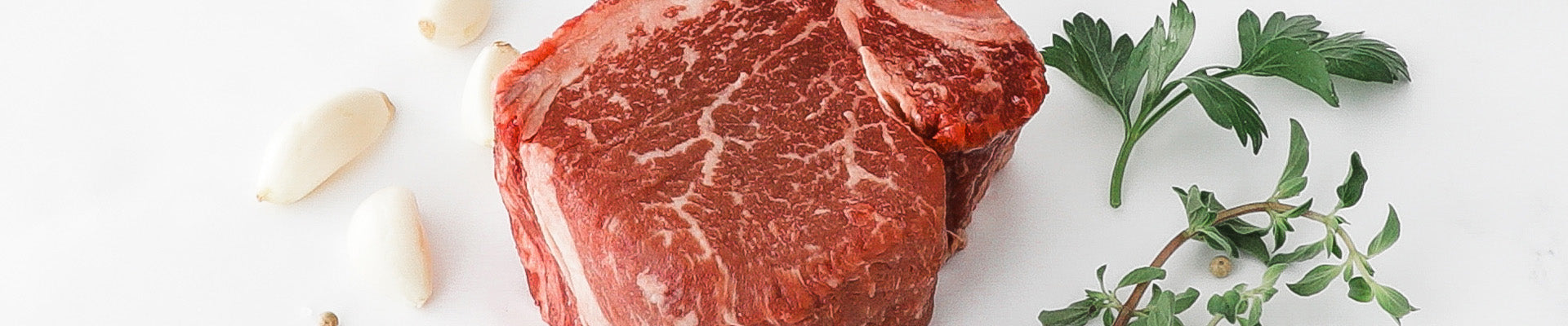 Raw Second City Prime meat with herbs.