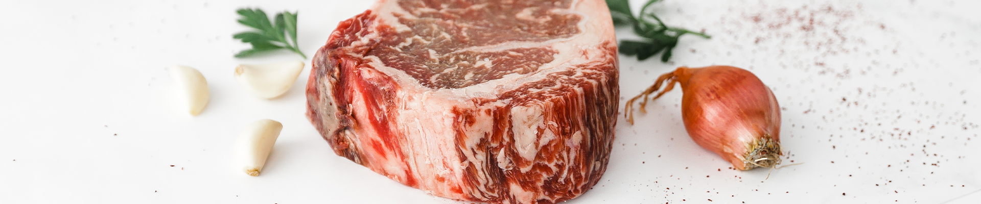 Cut of Dry-aged Bone-in Ribeye from Second City Prime.