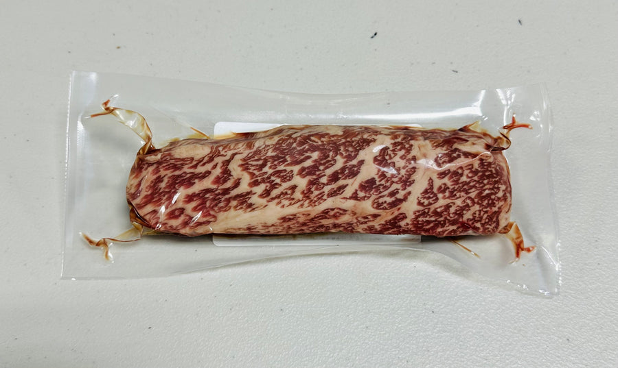 Stone Axe Wagyu Tri Tip MS 9+ (8oz): Richly marbled, raw steak.