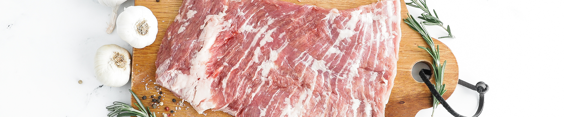 Raw Second City Prime pork with herbs and spices.