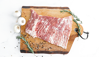 Raw Second City Prime pork with herbs and spices.